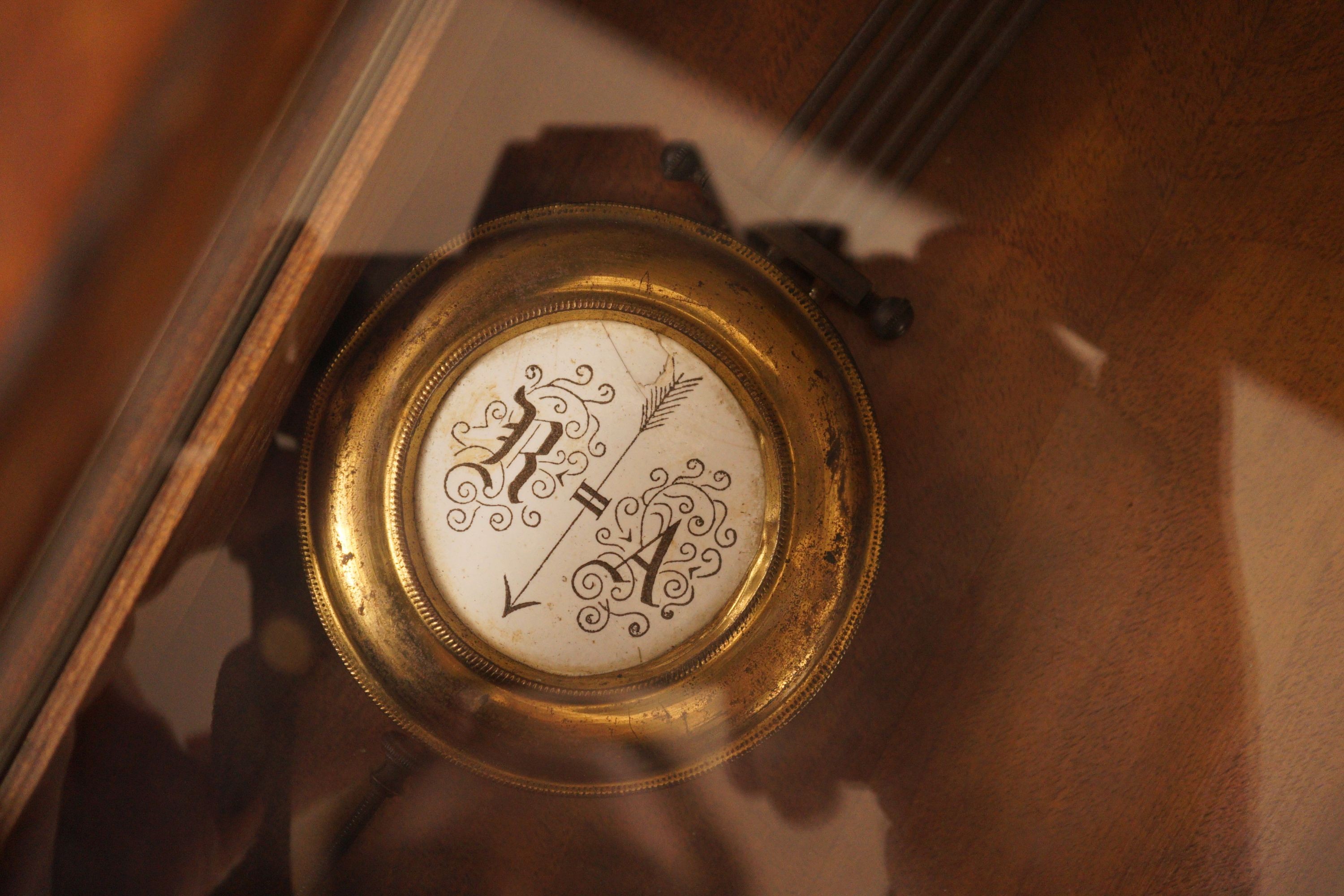 A small German wall clock with key, 58cm